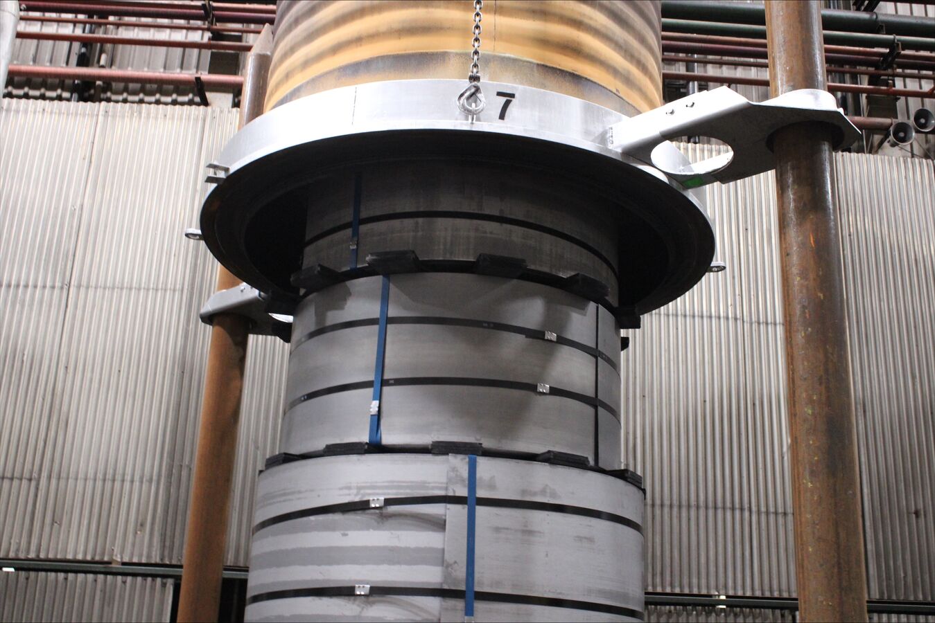 An open annealing furnace with stacks of coils ready for processing.