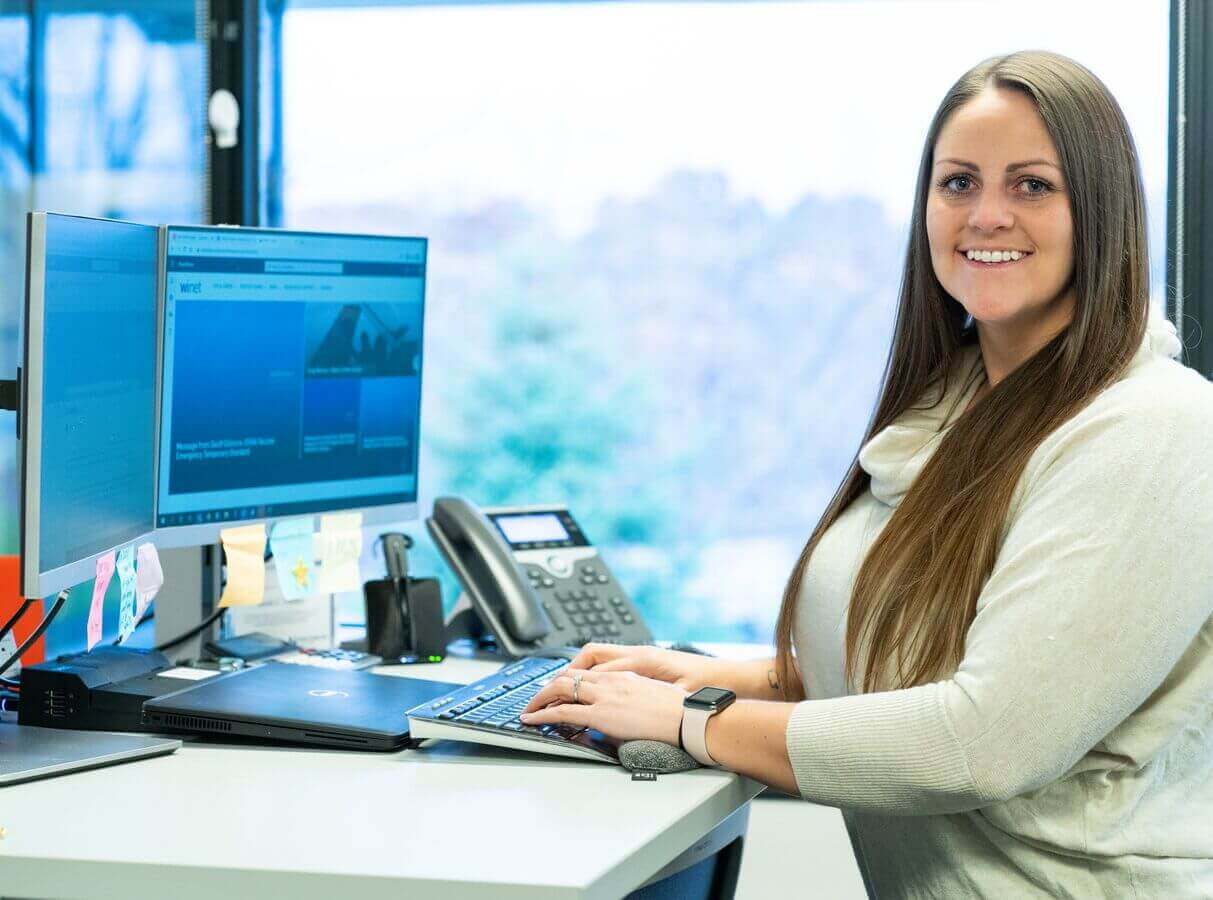 Customer support Worthington employee at desk.