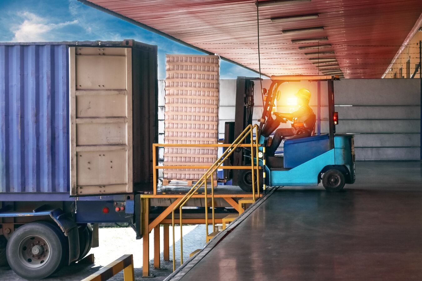 Forklift operator transporting packaged goods.