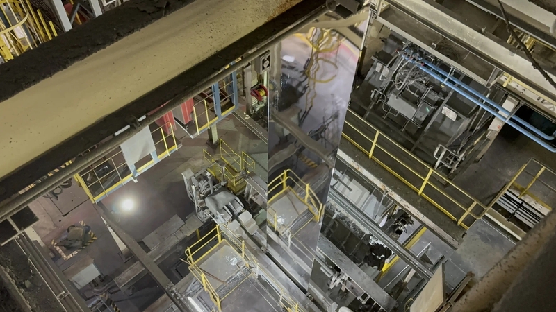 A coil of hot-dipped galvanized steel leaving the zinc pot during the steel galvanizing process on its way to the cooling tower.