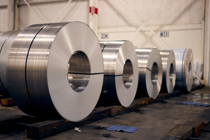 Five bound galvanized steel coil waiting on the shop floor for delivery.