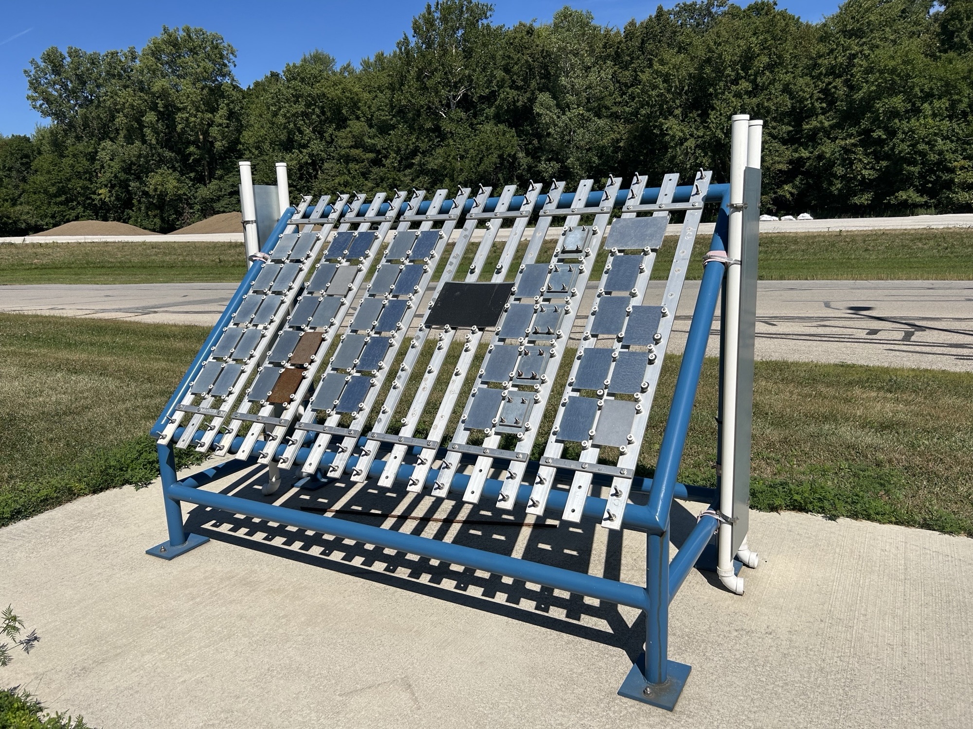 A side view of the outdoor exposure station beside the Delta facility. The samples are facing the sunlight.