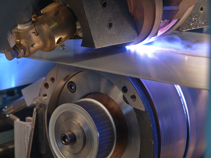 The welding of steel as it is being run between to machines.