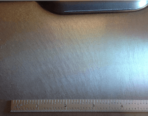 Closeup of steel surface indicating stretcher strain.