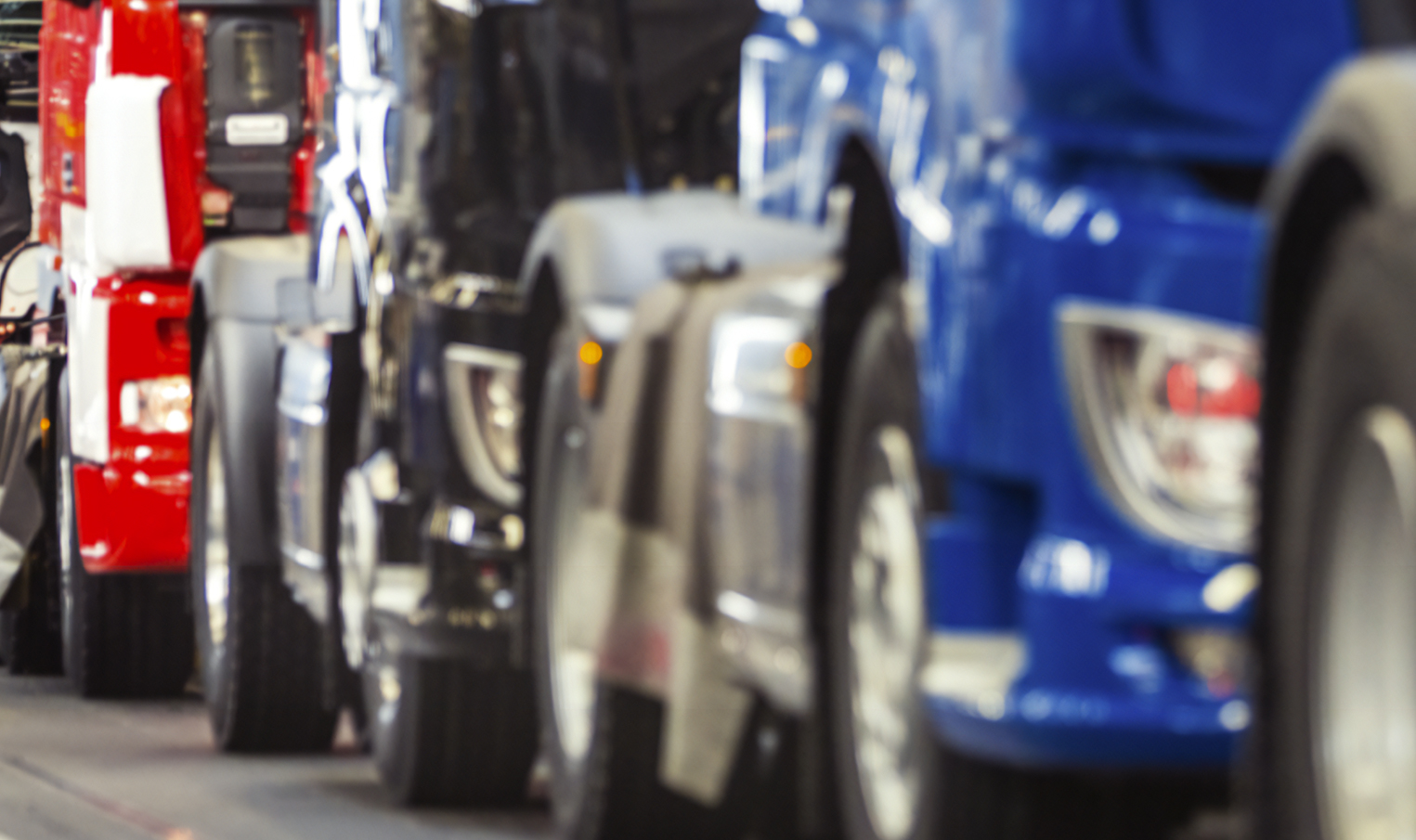 Close-up of semi-trucks in a production line, representing steel processed by Worthington Steel that goes into heavy trucks.